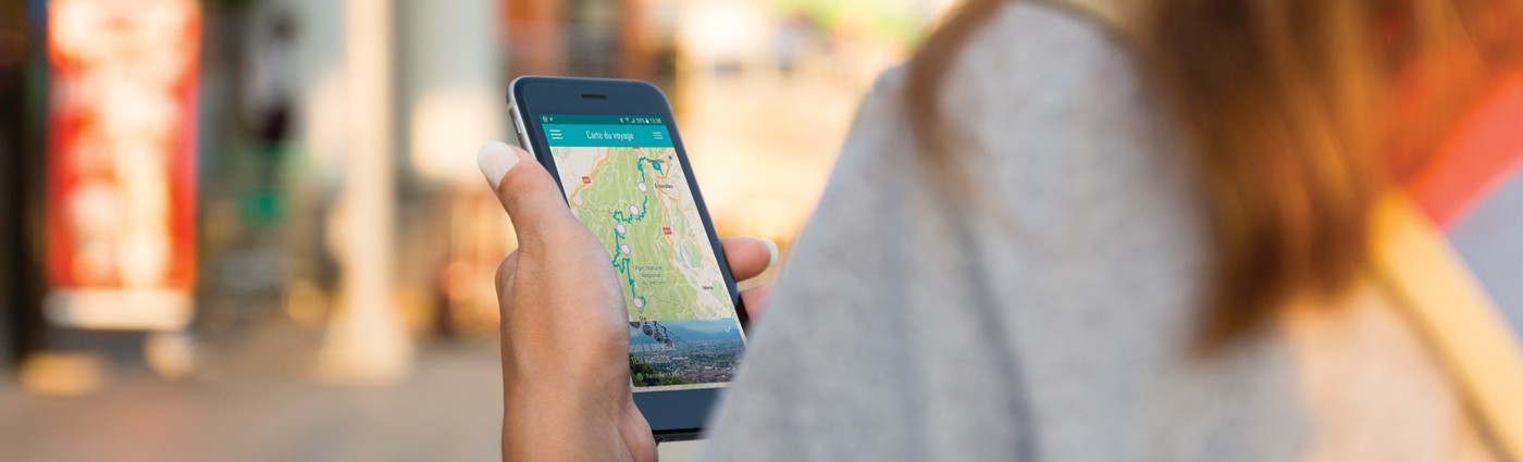 Traveller holding a smartphone with a route map