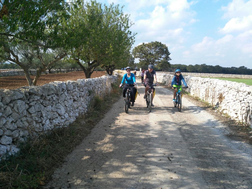 Cyclists among the trulli of the Itria Valley, Puglia