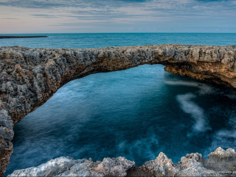 Ponte Sella, a natural rock arch over the Adriatic between Monopoli and Polignano a Mare